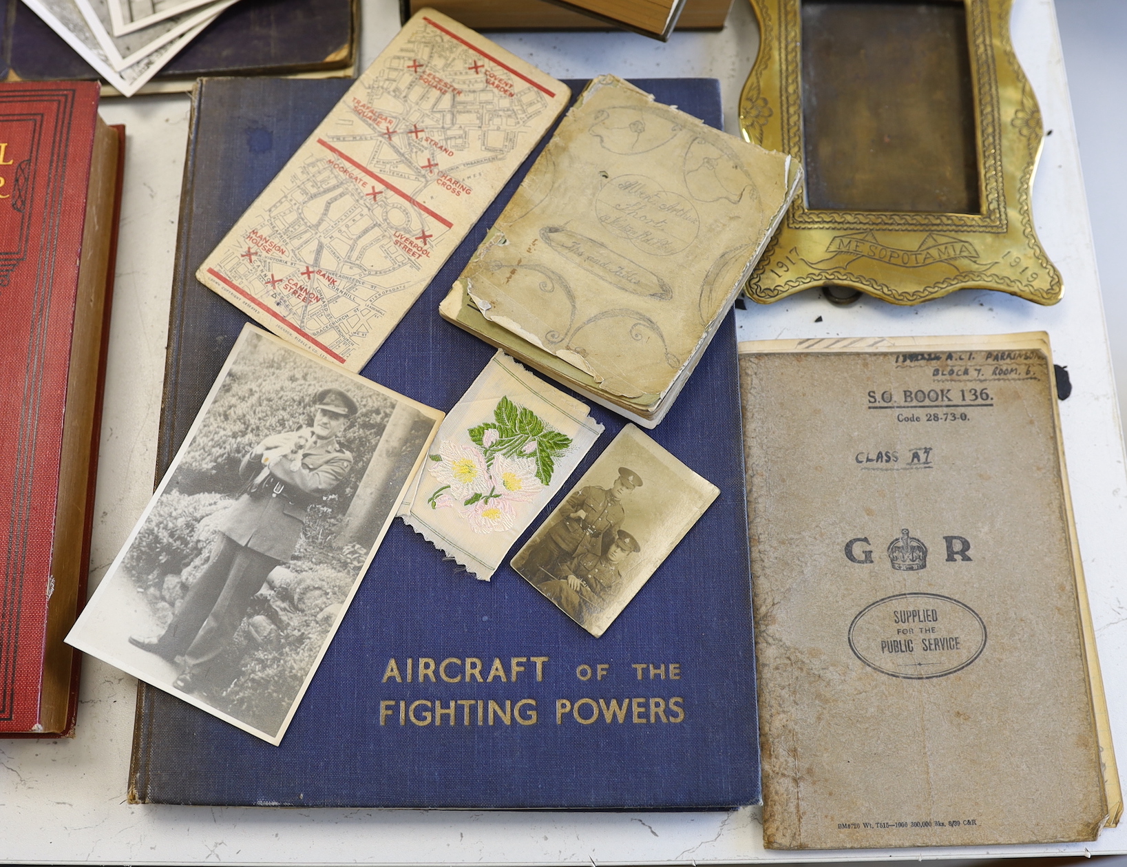 A quantity of war memorabilia including gas masks, postcards etc